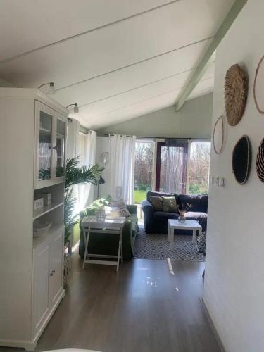 a living room with a couch and a table at Bungalow 049 in Petten