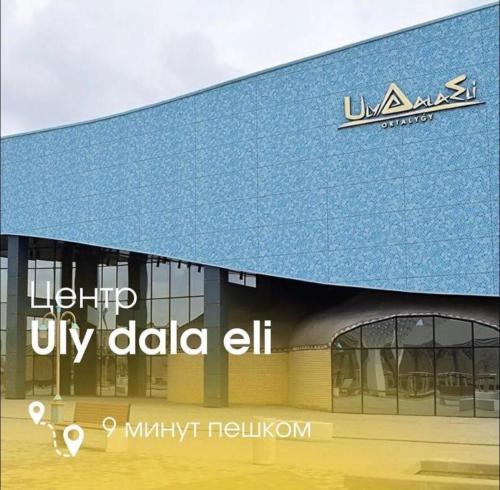 a view of a building with a sign on it at Keruen Saray Apartaments 1 in Türkistan