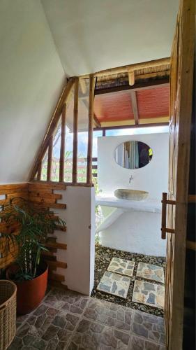 a small bathroom with a sink in a house at Ten Foundations in Balayan