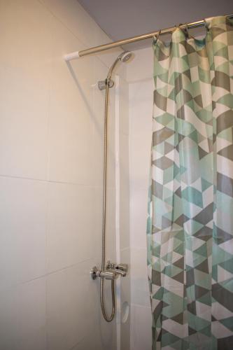 a shower in a bathroom with a shower curtain at Norita Alquiler Temporal - Departamento in La Rioja