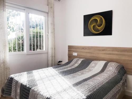 a bedroom with a bed with a blanket on it at Mary's house in Denia