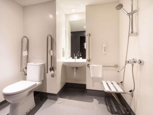 a white bathroom with a toilet and a sink at Ibis Budget Madrid Centro Lavapies in Madrid
