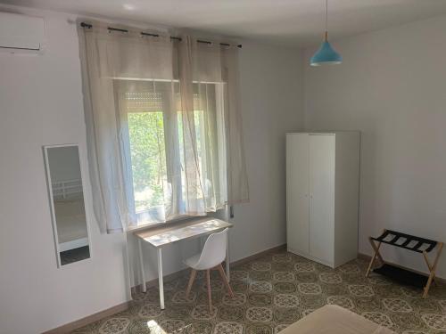 a room with a desk and a window and a chair at Villa with Garden near Rome for Groups & Families in Orte