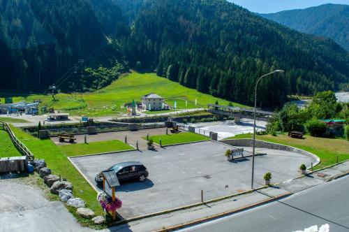 a parking lot with a car parked in a park at Hotel Serena - Tre Cime Views in Auronzo di Cadore