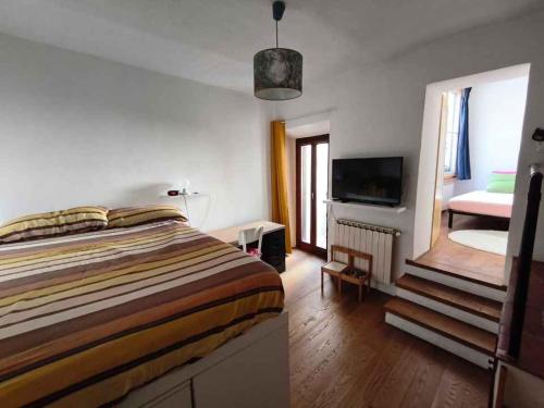 a bedroom with a bed and a television in it at Residenza La Terrazza in Arezzo