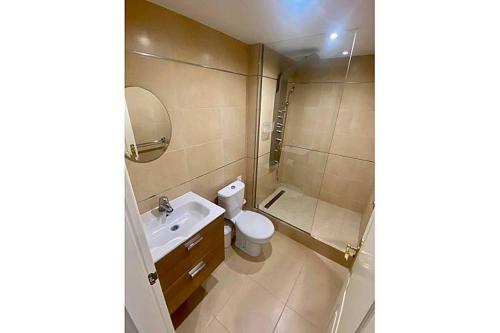 a bathroom with a toilet and a sink and a shower at Townhouse in Manilva in Manilva