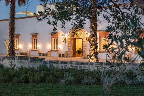 a home with a lit up front door at Tenuta Mosè Charming House&Relais Gallipoli in Gallipoli