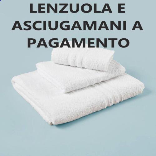 a stack of white towels sitting on a table at Villa Aurora 1 in Torre Lapillo