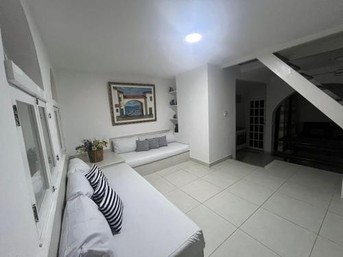 Ein Bett oder Betten in einem Zimmer der Unterkunft Casa em condomínio a 50mt da praia dos ossos