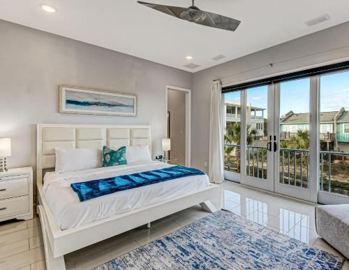 a bedroom with a bed and a large window at Ocean View Modern in Tybee Island