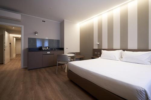 a hotel room with a bed and a kitchen at CA' San Cristoforo in Milan