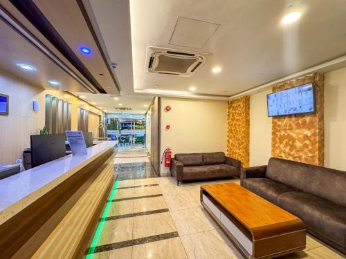a waiting room with a couch and a table at THE STARION HOTEL BUKIT BINTANG in Kuala Lumpur