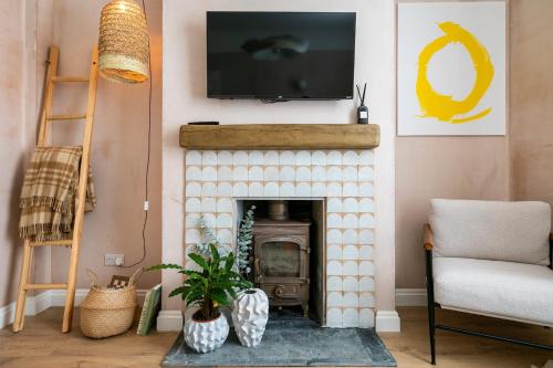 a living room with a fireplace with a tv above it at no.five Flushing in Flushing