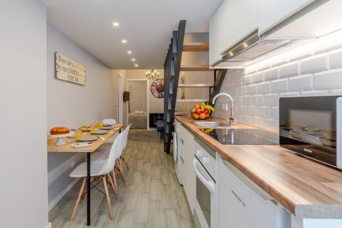 a kitchen with a table and a counter top at City Views Flats in Historic Porto by HostWise in Porto
