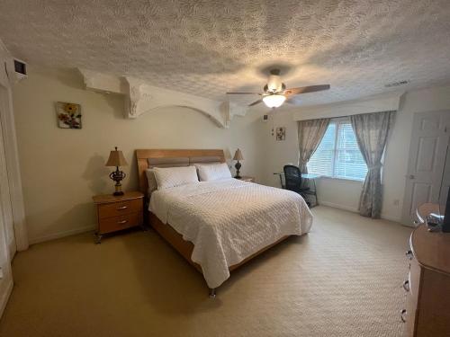 a bedroom with a bed and a ceiling fan at Woodland Apartments in Marietta
