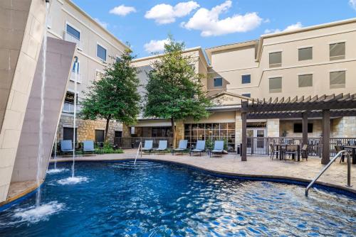 a swimming pool with a fountain in a building at Homewood Suites Dallas-Frisco in Frisco