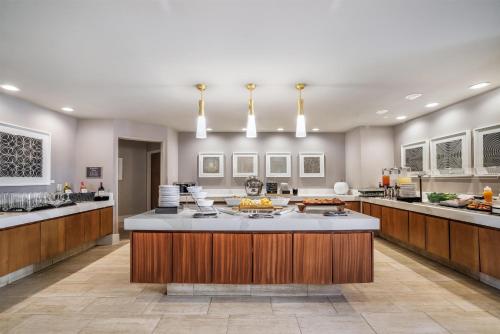a large kitchen with a large island in the middle at Homewood Suites Dallas-Frisco in Frisco