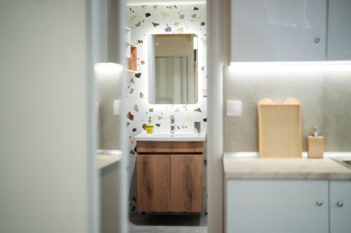 une salle de bain avec un lavabo et un miroir dans l'établissement Aegeas Home 2, à Kavala