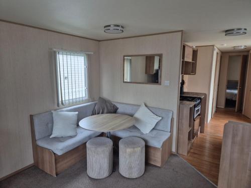 a living room with a couch and a table at Caravan by the Sea 641 in Kinmel Bay