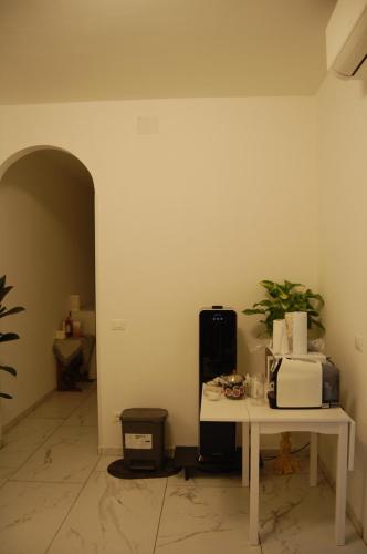 a room with a white table and a microwave at Orchidea Stazione in Bologna