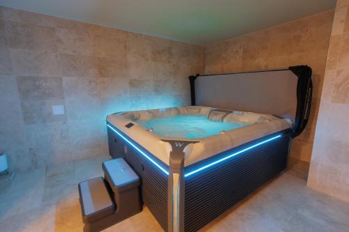 a hot tub in the corner of a room at Quantara Resort Domaša in Holčíkovce