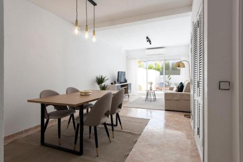 a dining room and living room with a table and chairs at NUZZA - Vilamoura Marina with BBQ in Vilamoura