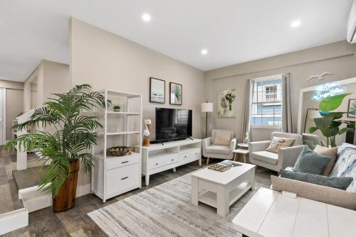 a living room with a couch and a tv at The Queen's Quarters - King Bed - AC - Walkable in Christiansted