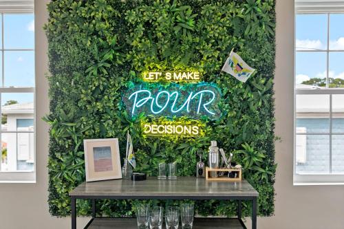 a green wall with a table in front of it at The Queen's Quarters - King Bed - AC - Walkable in Christiansted