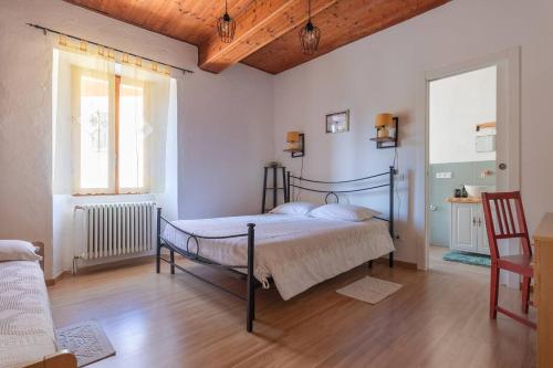 a bedroom with a bed in the middle of a room at Casa con terrazza panoramica sul lago Maggiore in Maccagno con Pino e Veddasca