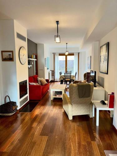 a living room with a couch and a table at Casa exclusiva l Wifi l Garaje l Pool in Biescas