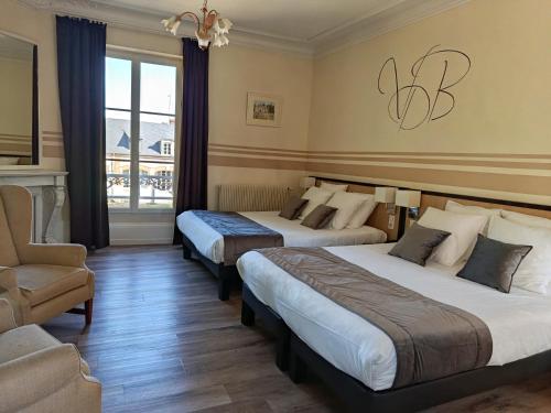 a hotel room with two beds and a chair at Logis Hotels Restaurants- Villa des Bordes in Cléry-Saint-André
