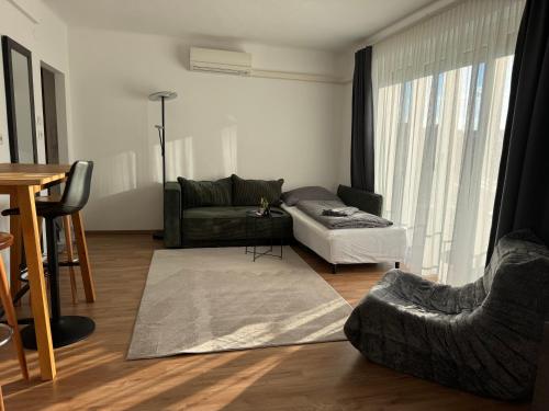 a living room with a couch and a table at 1A Wohntraum in Graz