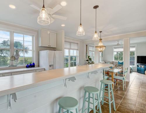 a kitchen with a large counter and stools at North Beach Outlook in Tybee Island