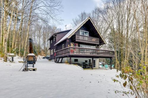 a large wooden house in the snow with trees at Pet-Friendly Home with Deck 4 Mi to Jay Peak Resort in Montgomery Center