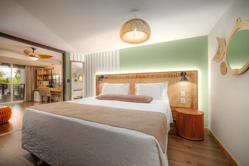 a bedroom with a large bed and a mirror at Pousada dos Sonhos in Florianópolis