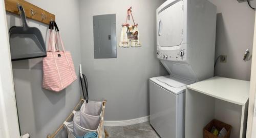 a small laundry room with a washer and dryer at Newly Renovated Villa with Hot Tub in Fort Lauderdale