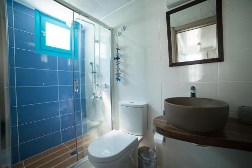 a bathroom with a sink and a toilet and a shower at Villa Stella Apartments by Estia in Stalida