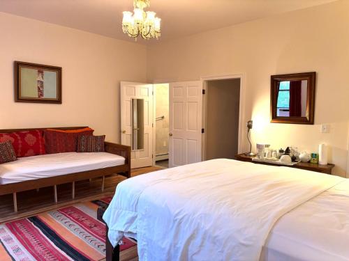 a bedroom with a large white bed and a couch at Luxurious bedroom in New York