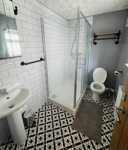 a bathroom with a shower and a toilet and a sink at Market Valley in Abertillery