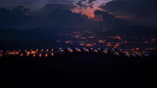 a group of umbrellas on a hill at night at Husaak Tabab Adventure Lodge 