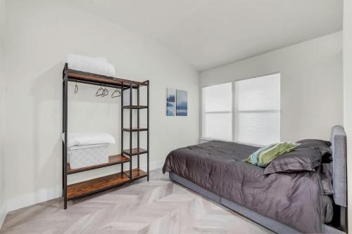 a bedroom with a bed and a book shelf at Cozy studio in quiet area - Yard in Austin