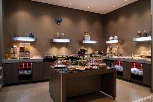 a buffet line in a restaurant with a lot of food at Hampton By Hilton Bogota Airport in Bogotá