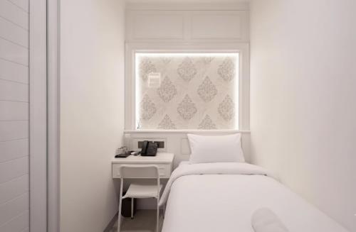 Postel nebo postele na pokoji v ubytování Wyneth Hotel Airport