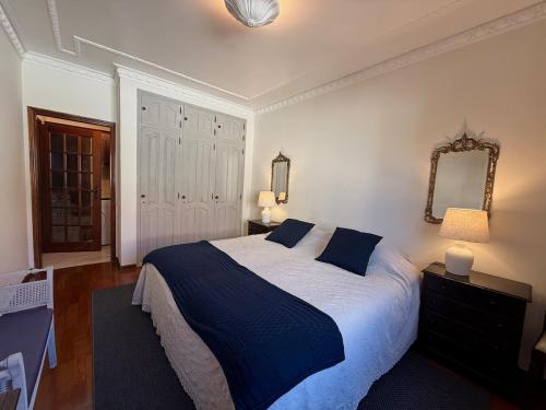 a bedroom with a large bed and a mirror at Fabulous Terrace 1 - Checkinhome in Cascais