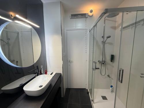 a bathroom with a sink and a shower with a mirror at Estrecha de San Andres in A Coruña