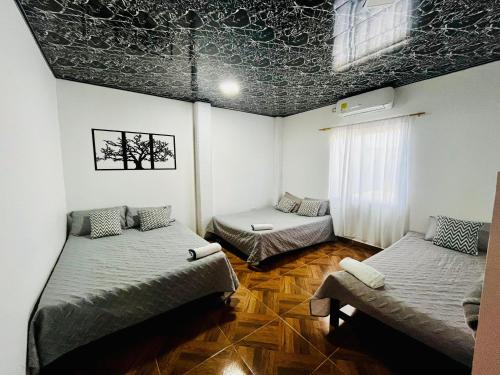 a room with two beds and a window at Villa Paraíso Nápoles in Doradal