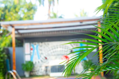 a house with a building in the background at The Angel Hotel Lagos in Lagos