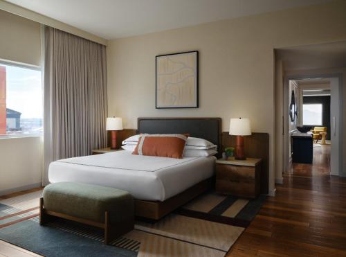 a bedroom with a large bed and a large window at Kimpton Hotel Palomar Phoenix Cityscape by IHG in Phoenix