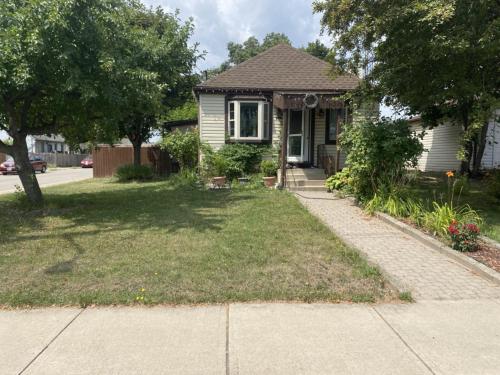a small house with a sidewalk in front of it at Oasis Of Peace in Hamilton