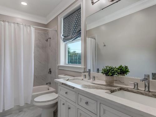 a bathroom with a sink and a toilet and a shower at Beachside Villa Unit 3 in Tybee Island